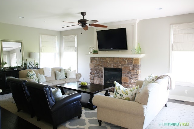 Stone fireplace with Behr Castle Path walls in living room.