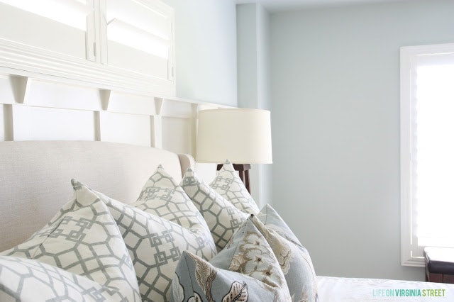 Master bedroom with Sea Salt painted walls, white board and batten trim, Schumacher Hothouse Flower pillows and Windsor Smith Pelagos shams