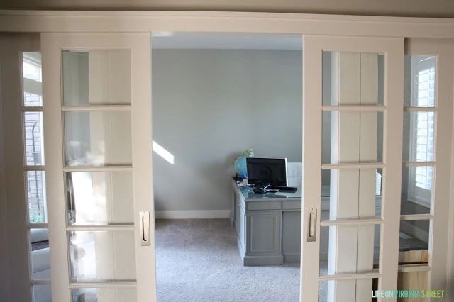 View of neutral office through French doors. 