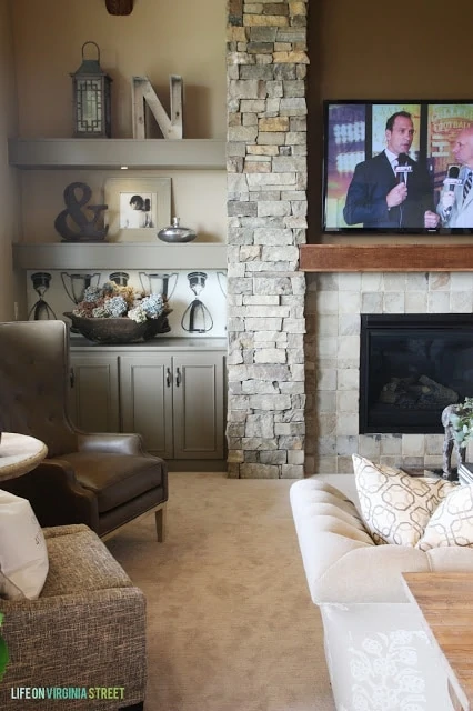 Stacked stone fireplace with gray built-in shelves. Love the look of this with the TV.