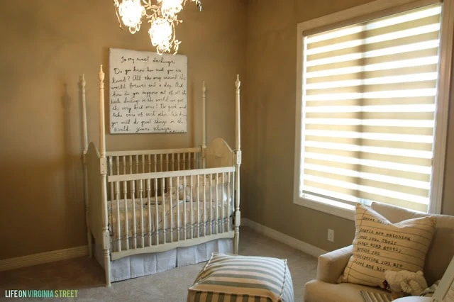 Nursery with Sugarboo Art, a Striped Pouf and French details.