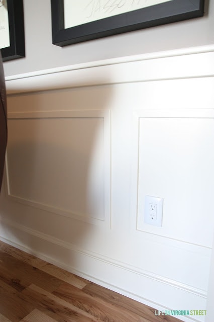 White wooden paneling on the wall behind the desk.