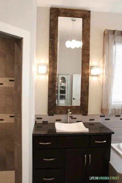 Long mirrors are above the bathroom vanity.
