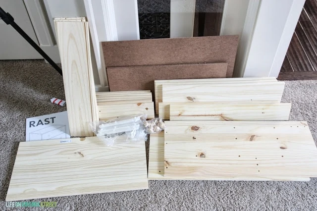An ikea dresser in pieces before it is being assembled.