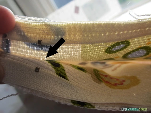 A black arrow pointing to where to stop sewing.