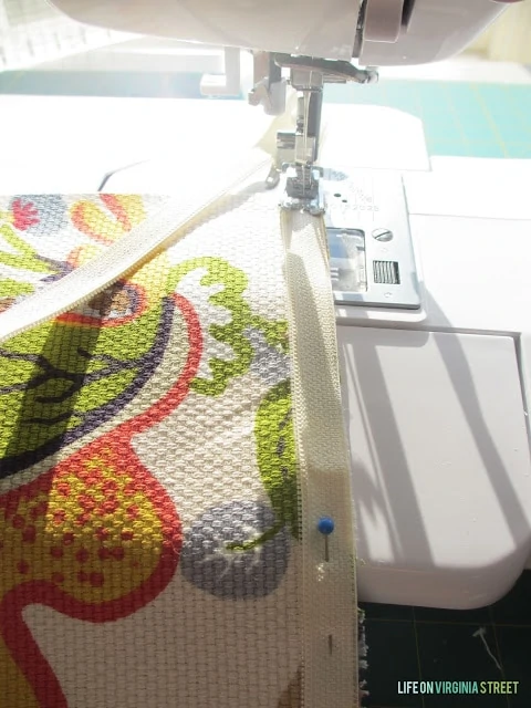 A sewing machine sewing the zipper in.