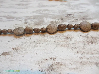 Up close of the wooden beads on a string.