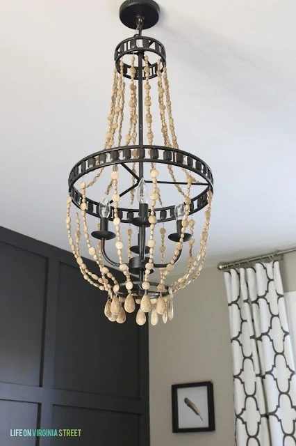 Wooden bead chandelier hanging up.