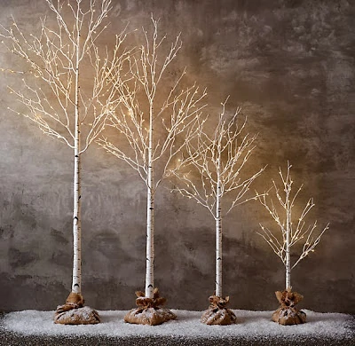Various sizes of mini trees with lights.