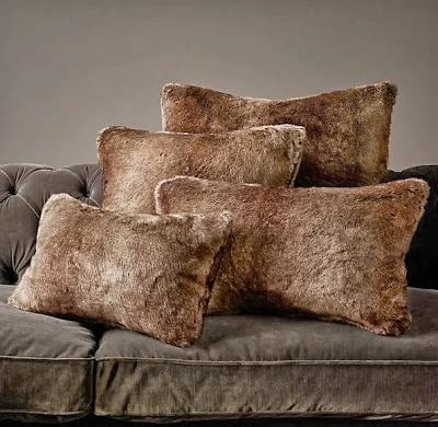 Faux fur pillows on a couch.