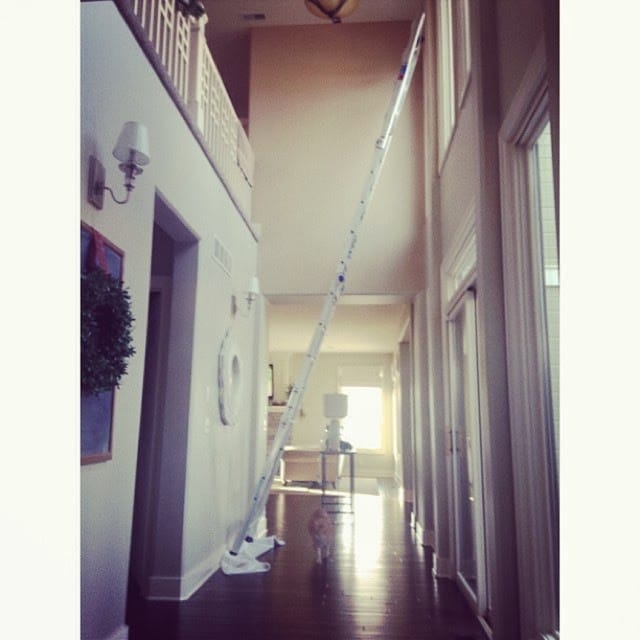 A ladder in the tall entryway of the home.