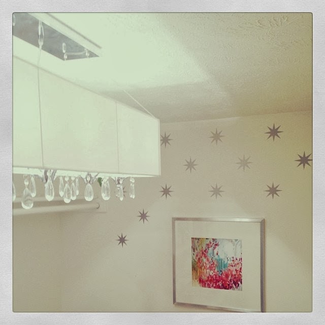 There are stars on the wall, plus a framed picture.