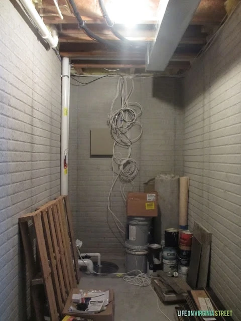 A hallway with exposed wires and various building materials.