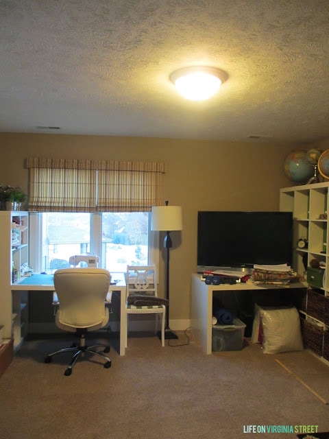 An office with a white desk, chair and carpet.
