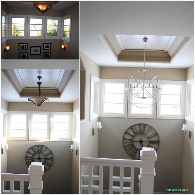 There is a hallway with a chandelier that is a globe at the top of the stairs.