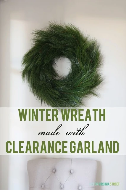 DIY Winter Wreath made from Clearance Garland with a white chair underneath it.