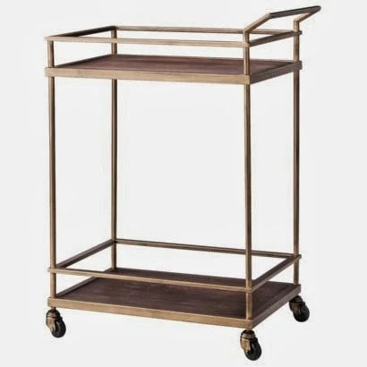 A rolling bar cart with a handle and two level shelves.
