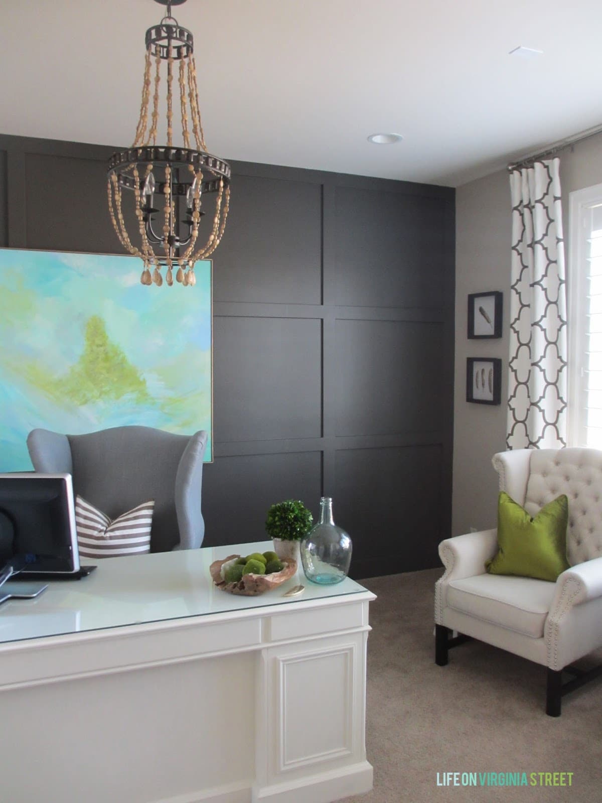 Home office makeover with Sherwin Williams Urbane Bronze board and batten wall, wood bead chandelier, and DIY abstract artwork.