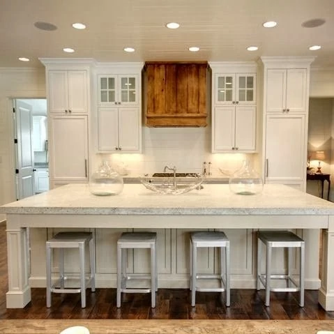 White kitchen with wood range hood