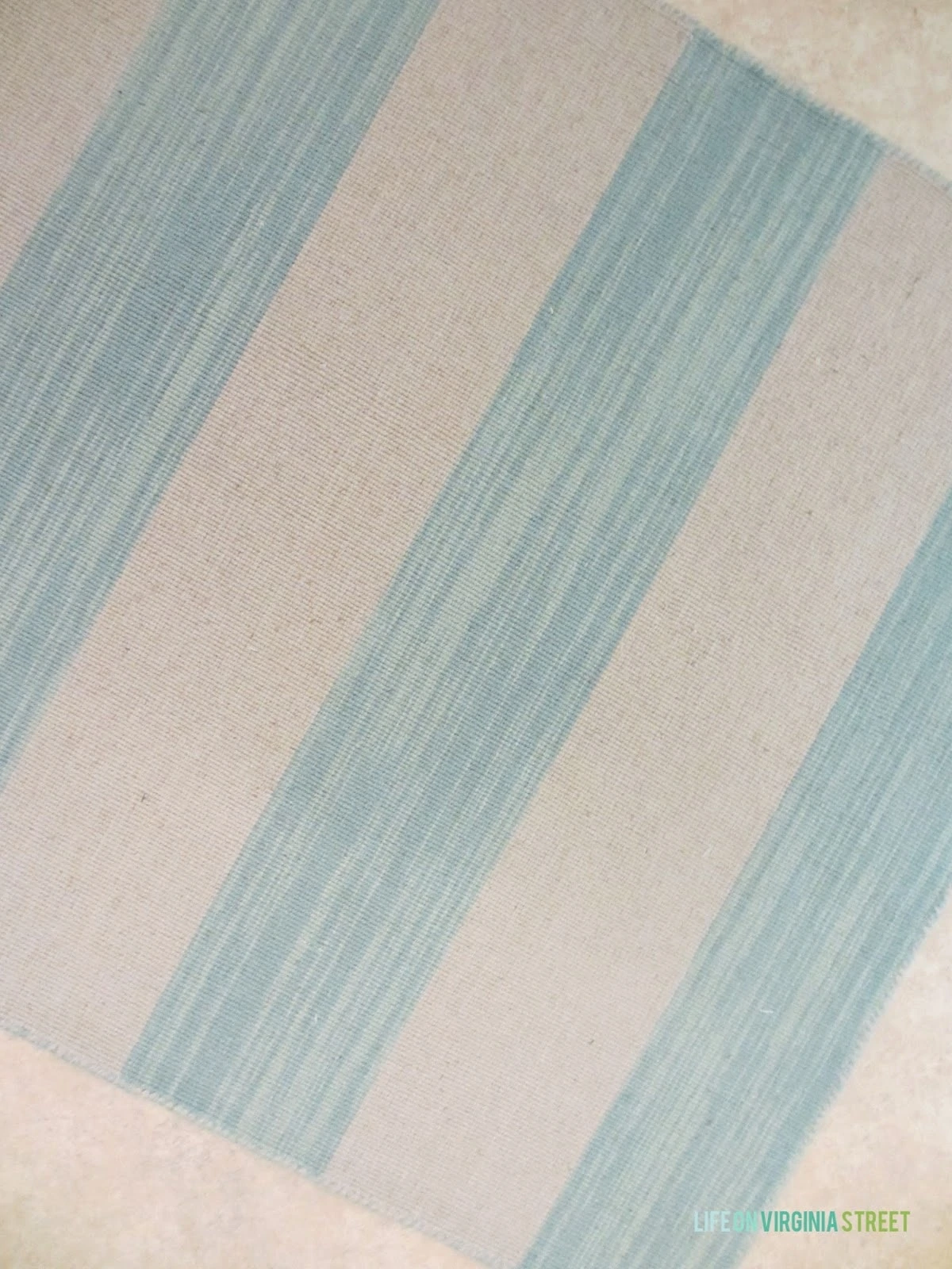 A blue and white striped rug on the floor.