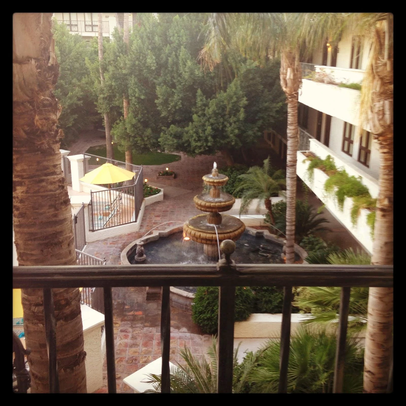 The courtyard of the hotel with a fountain in the middle.