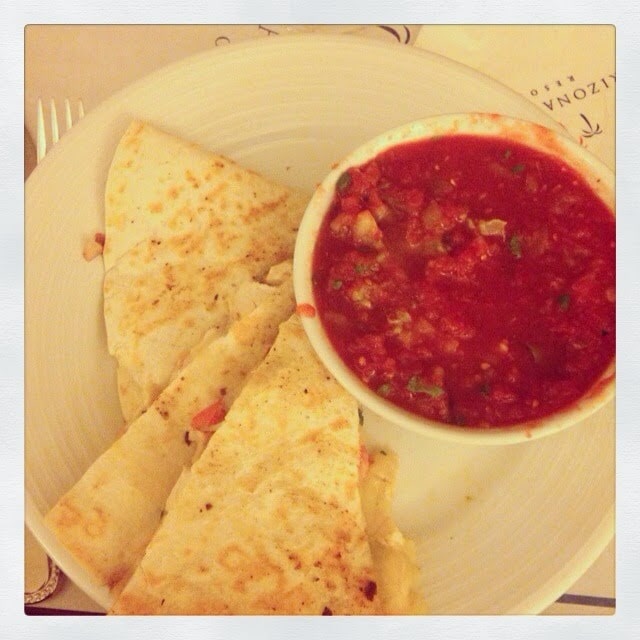 Chips and salsa on a plate.