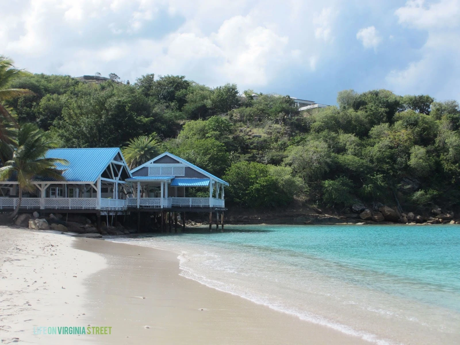 A house on stilts by the shore in the Caribbean.