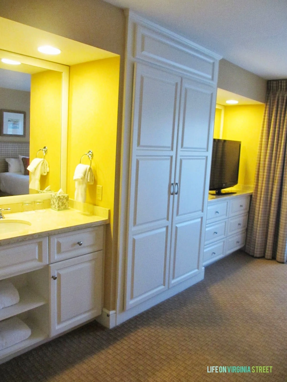 A bedroom vanity and large white closet.