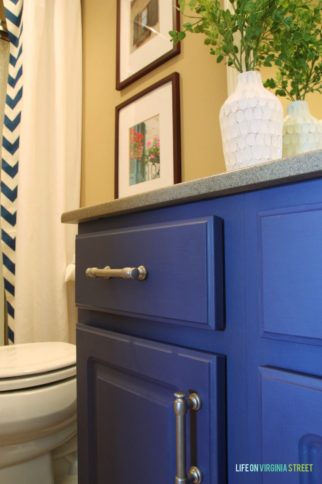 Blue cupboards in our guest bathroom with silver hardware. 