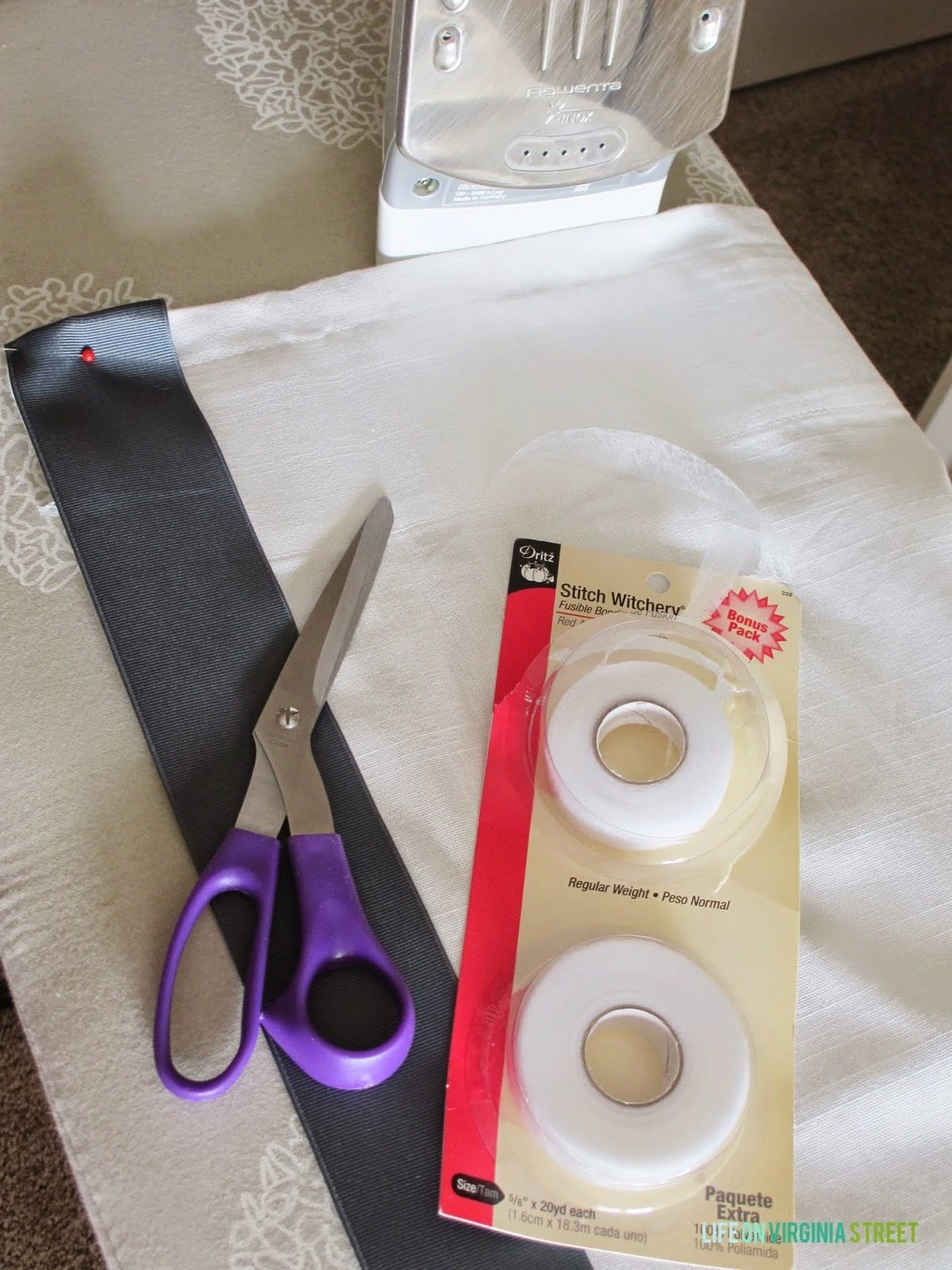 Fabric, scissors, stitch tape on the counter.