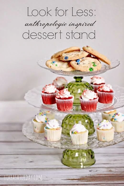 Dessert stand with cupcakes and cookies on it.