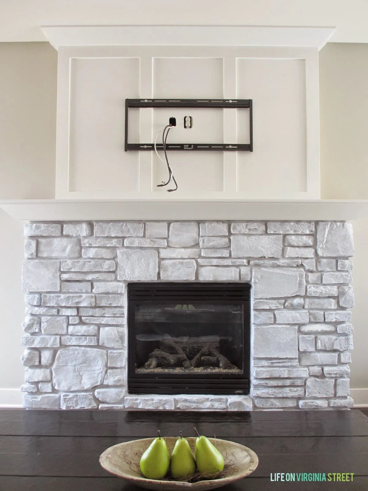 Whitewashed stone fireplace makeover and reveal.