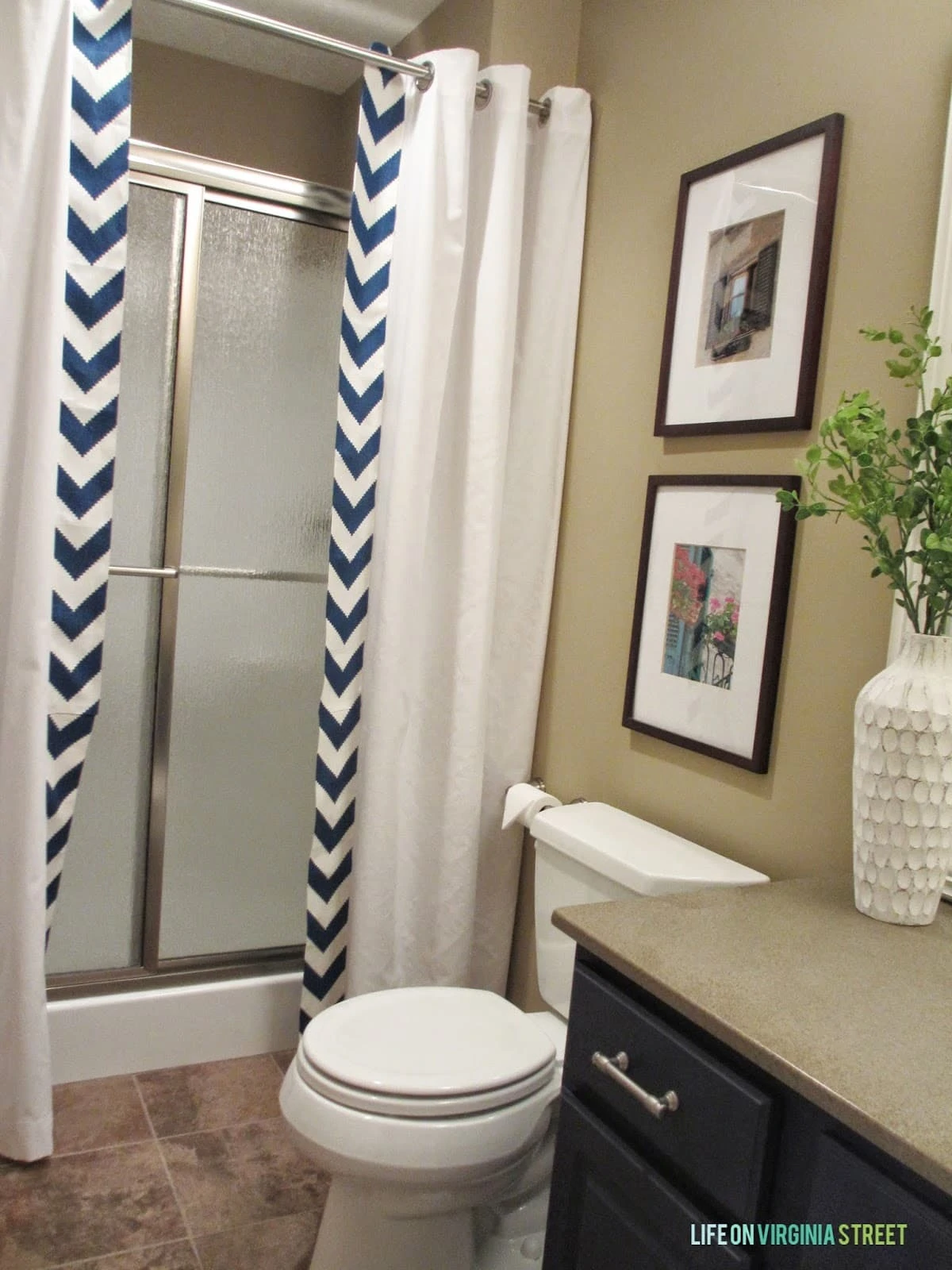 Guest bathroom makeover with chevron DIY shower curtain and navy sink. 