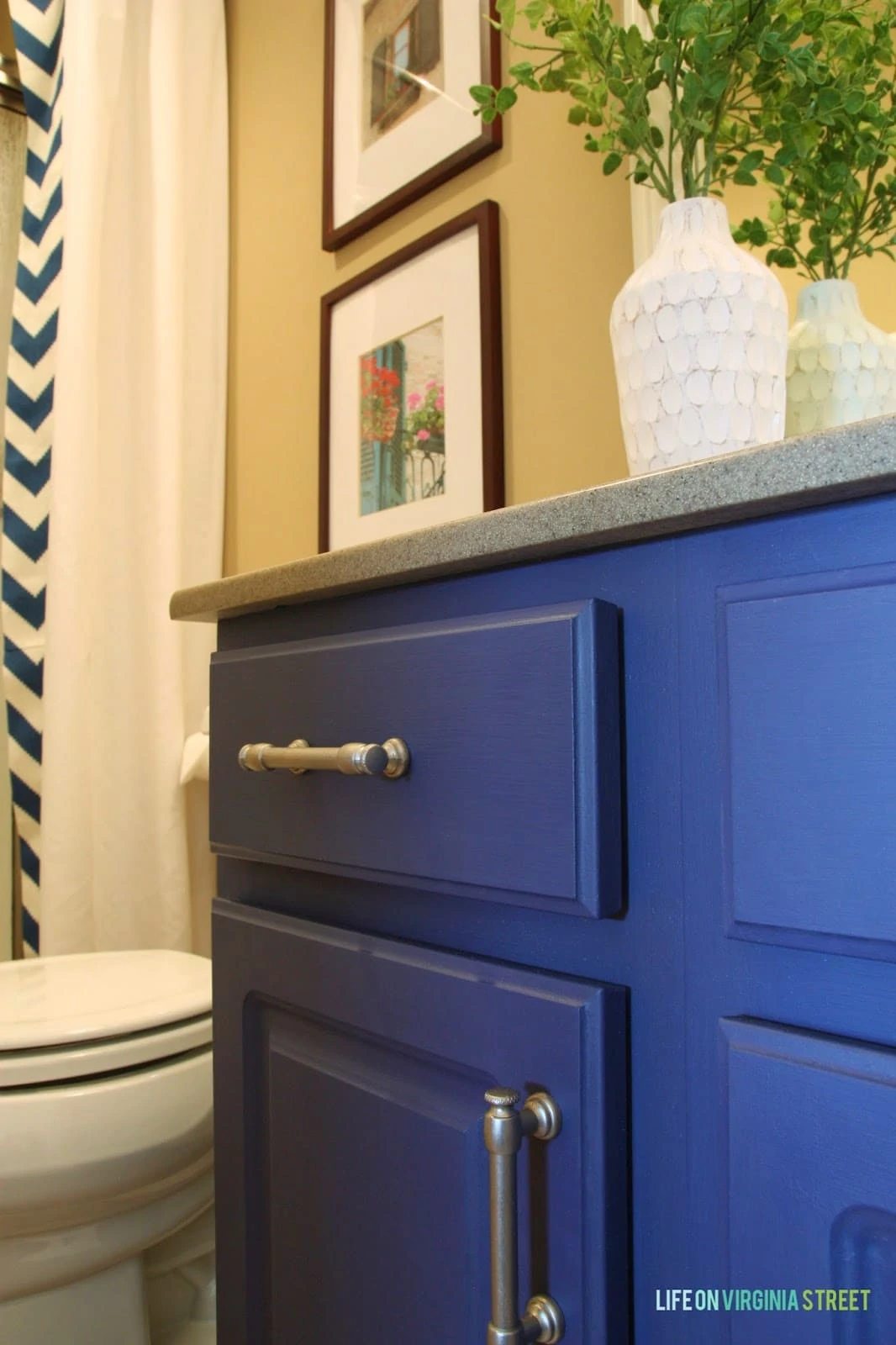 Painted laminate bathroom cabinets in bold blue.