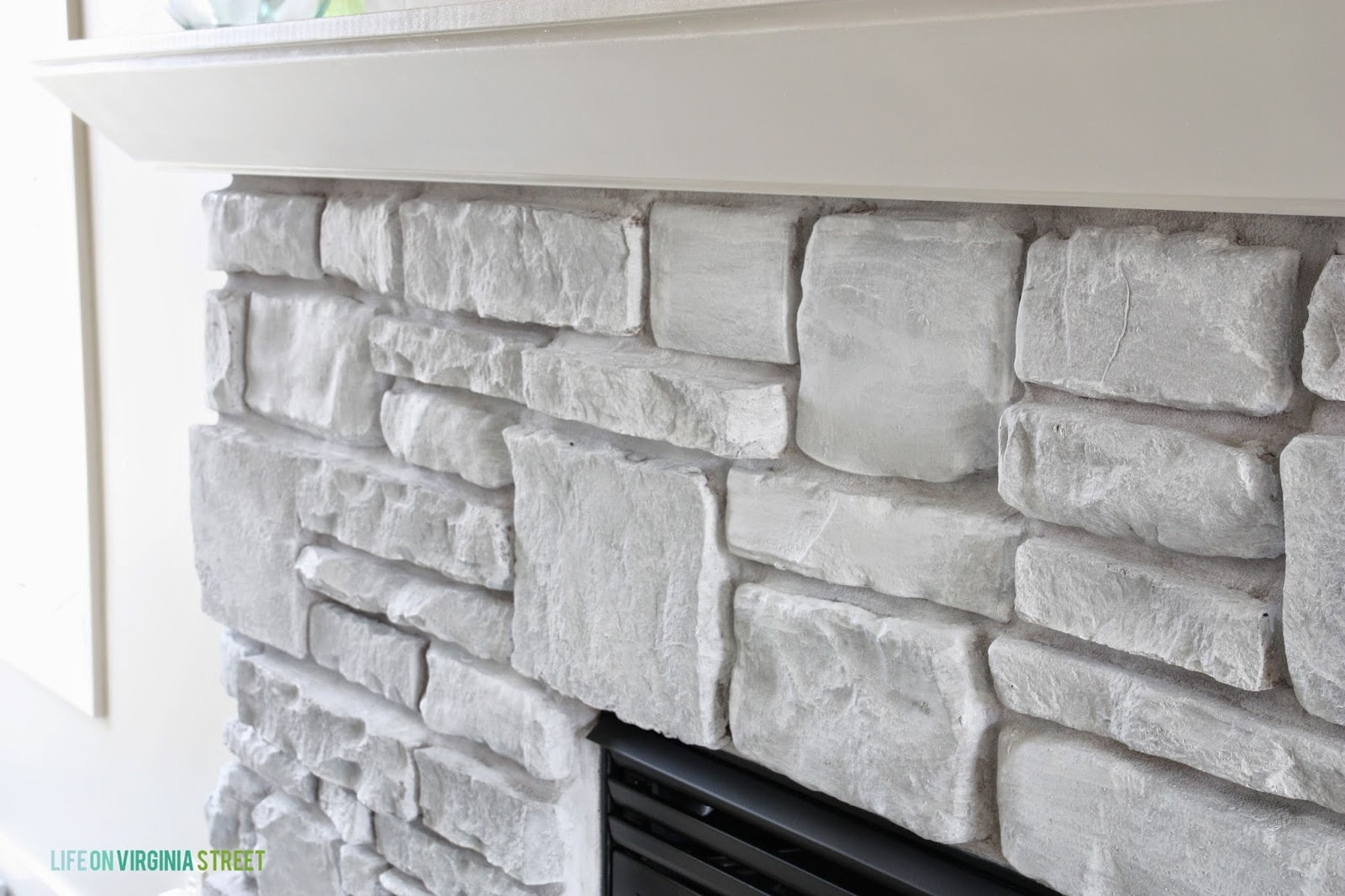 whitewash stone fireplace before and after