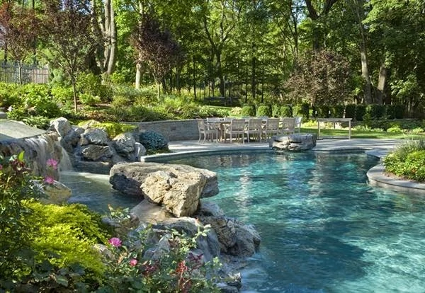This pool landscaping is similar to what I would like to see. Rugged, with a waterfall feature.