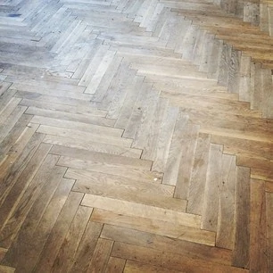 A distressed looking hardwood floor.