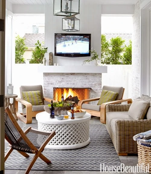 This outdoor patio has a similar theme - creating a fireplace wall to block the neighbor's view!