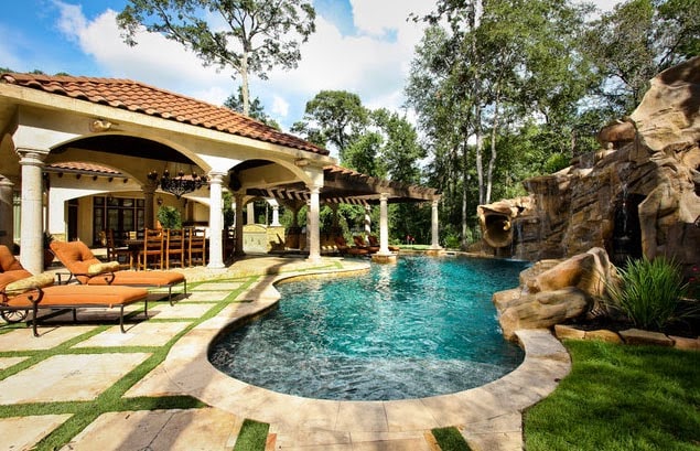 I love the patio with the stone/grass mix in this backyard. Also love the rounded edges of the pool.