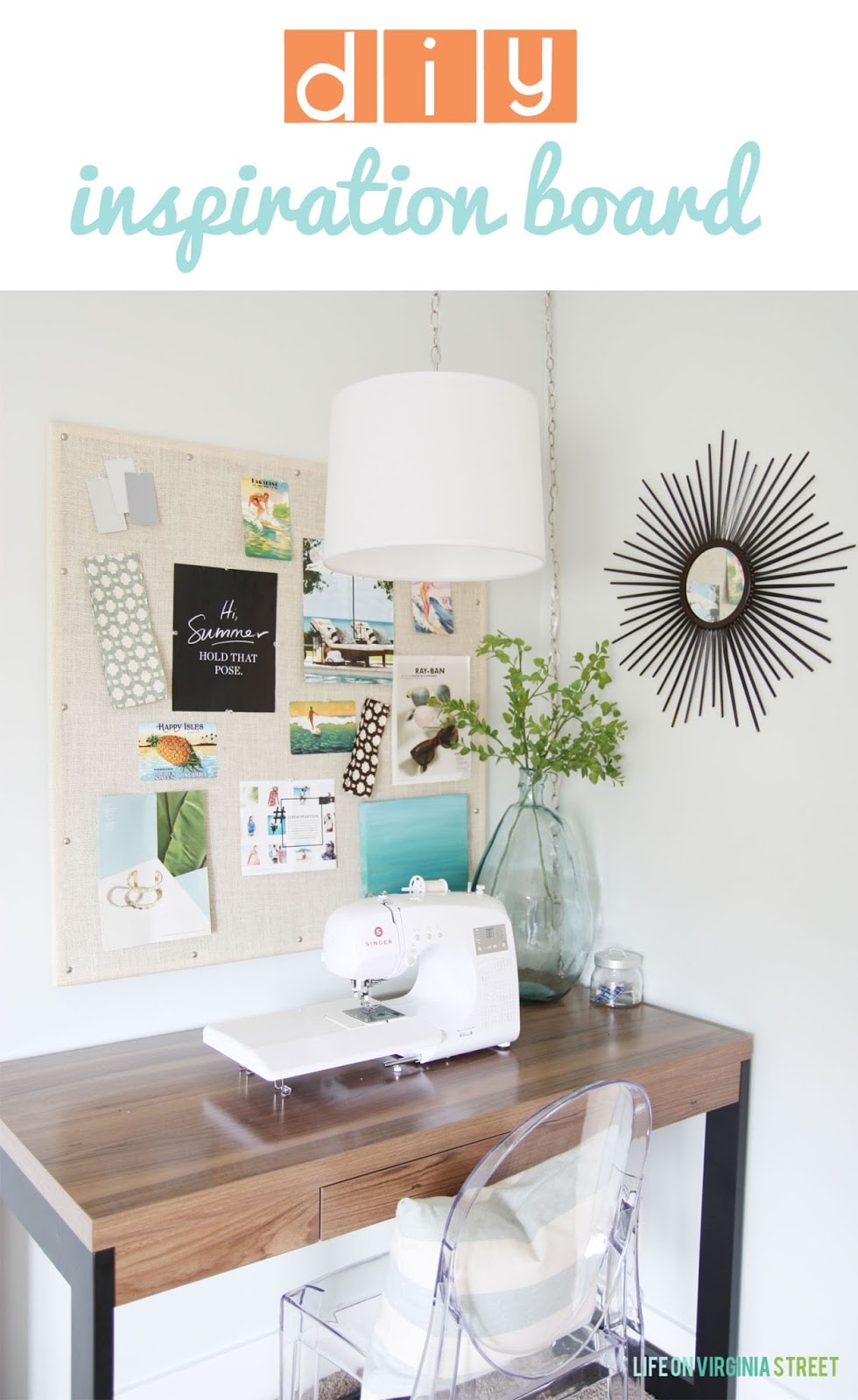 A small desk with a sewing machine on it and an inspiration board above it.