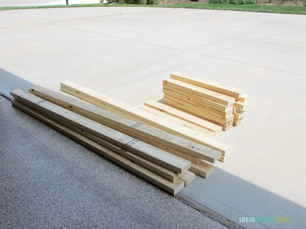 The supplies you'll need for this outdoor couch- only some 4x4s from the hardware store lying on driveway.