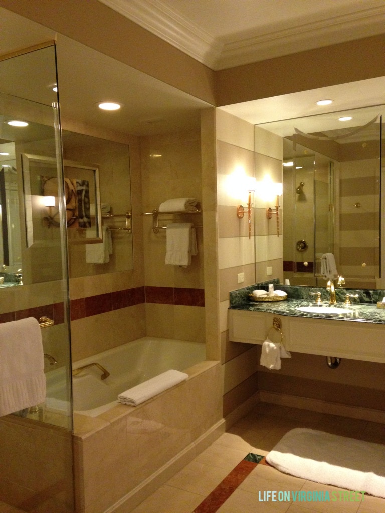 The bathroom in the Venetian with a large tub and mirror.