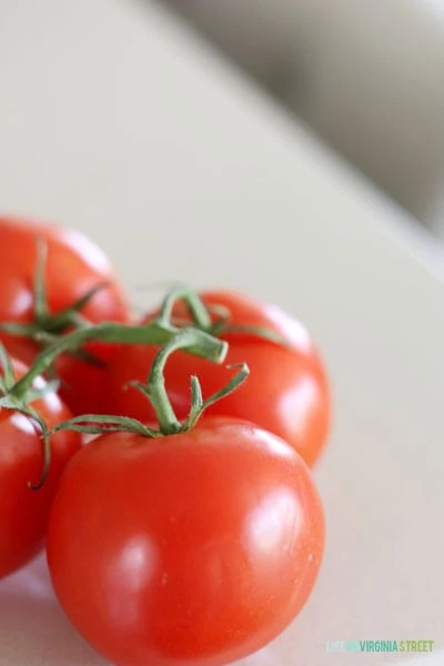 Up close picture of tomatoes on the counter.