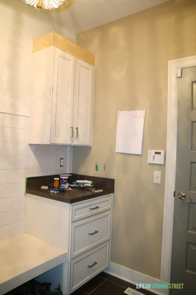 White cabinets in the mudroom with drawers.