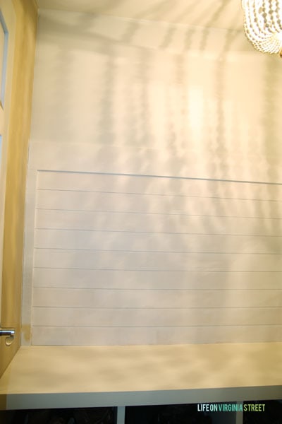 A small bench with storage underneath in the mudroom.