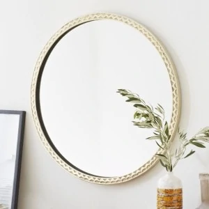 Look at the beautiful accents on this thin textured brass round mirror. 