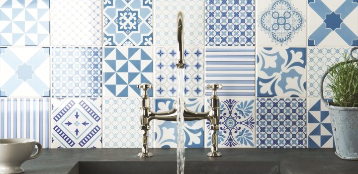 blue and white concrete tile kitchen backsplash with silver faucet.