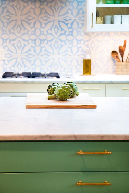 .White and Blue Tile with Green Cabinets from House & Home. I love the way this blue and white pattern looks with the countertops.
