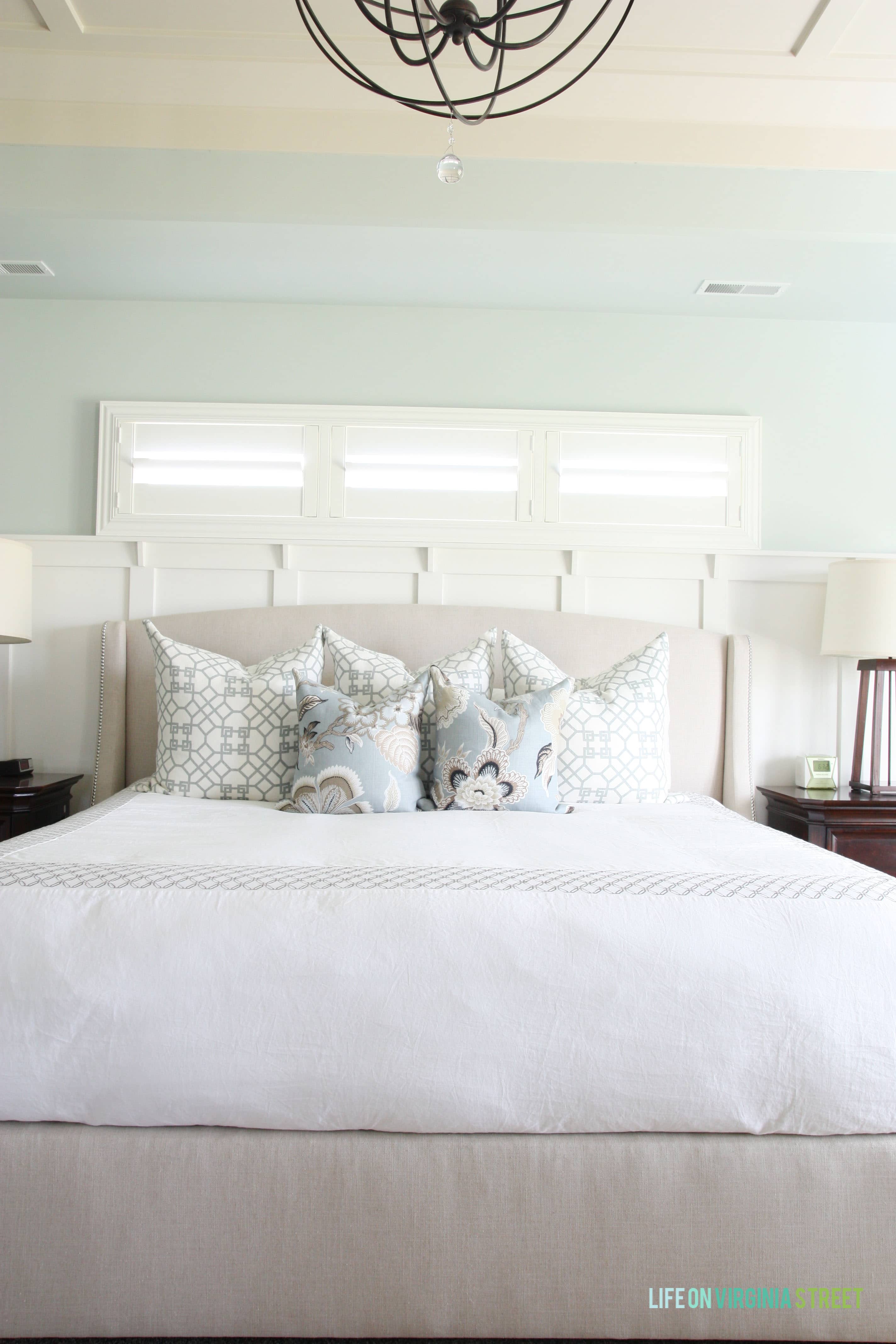 A serene master bedroom with Sherwin Williams Sea Salt walls. Such a pretty green-blue color that gives a spa-like appearance to any room!