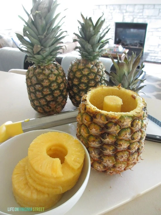 The cored pineapple with the round circles pineapple in the bowl.